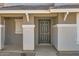 Close up of the gray front door with sidelights and the house number visible at 5828 E Hampton Ave, Mesa, AZ 85206