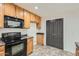 The kitchen features wood cabinets, black appliances, and opens to the living area at 5828 E Hampton Ave, Mesa, AZ 85206