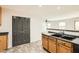 The kitchen is equipped with wood cabinets, black appliances, and a breakfast bar at 5828 E Hampton Ave, Mesa, AZ 85206