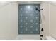 Close-up of the bathtub featuring a patterned blue accent wall and sleek fixtures at 660 E 1St Ave, Mesa, AZ 85204