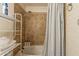 Bathroom with tiled shower/tub combo, white shelf, and chrome fixtures offers a clean and functional design at 660 E 1St Ave, Mesa, AZ 85204