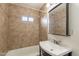 Tiled bathroom featuring a shower-tub combo, a modern sink and vanity, and a large, well-lit mirror at 660 E 1St Ave, Mesa, AZ 85204