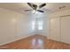 Stylish bedroom with hardwood floors, a ceiling fan, double windows, and a built-in closet for storage at 660 E 1St Ave, Mesa, AZ 85204