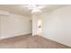 Inviting bedroom featuring neutral carpet, a ceiling fan, and direct access to a conveniently located kitchen at 660 E 1St Ave, Mesa, AZ 85204