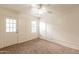 Versatile bedroom space with neutral carpet, access to the outdoors, and a ceiling fan for climate control at 660 E 1St Ave, Mesa, AZ 85204