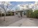 Charming home features gravel landscaping, lush shrubs, and a concrete driveway at 660 E 1St Ave, Mesa, AZ 85204