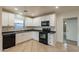 A modern kitchen featuring black appliances, sleek countertops, and ample cabinet space for storage at 660 E 1St Ave, Mesa, AZ 85204
