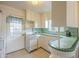 Functional kitchen featuring white appliances and a decorative green tiled countertop at 660 E 1St Ave, Mesa, AZ 85204