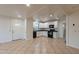 Spacious kitchen with black appliances, white cabinets, and a light-filled adjacent living area at 660 E 1St Ave, Mesa, AZ 85204