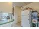 Cozy kitchen showing a white refrigerator and adjoining breakfast nook at 660 E 1St Ave, Mesa, AZ 85204