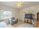 Cozy living room featuring a chair, a ceiling fan, and tiled flooring at 660 E 1St Ave, Mesa, AZ 85204