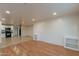 Open-concept living area featuring a kitchen with black appliances and white cabinetry at 660 E 1St Ave, Mesa, AZ 85204