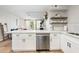 Kitchen with white cabinetry, a breakfast bar, and seamless transition to living spaces at 7625 E Camelback Rd # A336, Scottsdale, AZ 85251