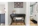 Home office featuring a black desk and a view into the bathroom with white cabinetry at 7625 E Camelback Rd # A336, Scottsdale, AZ 85251