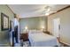 Bedroom featuring a ceiling fan, side tables, and colorful area rug at 7807 E Main St # H12, Mesa, AZ 85207
