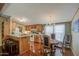 Dining area with adjacent kitchen with a breakfast bar and updated lighting at 7807 E Main St # H12, Mesa, AZ 85207