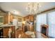 Dining area with adjacent kitchen with a breakfast bar and updated lighting at 7807 E Main St # H12, Mesa, AZ 85207