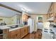 Bright and airy kitchen with wood cabinets and breakfast bar overlooking Gathering room at 7807 E Main St # H12, Mesa, AZ 85207