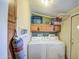 Functional laundry room with white washer and dryer, and ample storage cabinets at 7807 E Main St # H12, Mesa, AZ 85207