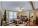 The cozy living room is furnished with stylish decor and a ceiling fan at 7807 E Main St # H12, Mesa, AZ 85207