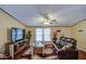 Inviting living room with a ceiling fan and a rustic entertainment center at 7807 E Main St # H12, Mesa, AZ 85207
