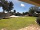 A spacious backyard with grass and a pool at 8179 W Clara Ln, Peoria, AZ 85382