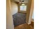 Spacious bedroom featuring plush carpet, vaulted ceiling, and a large window providing natural light at 8179 W Clara Ln, Peoria, AZ 85382