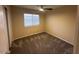 Bedroom featuring a ceiling fan, plush carpet, and a window providing natural light at 8179 W Clara Ln, Peoria, AZ 85382