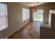 Cozy dining area with tiled floor, modern light fixture, and sliding door access to the backyard at 8179 W Clara Ln, Peoria, AZ 85382