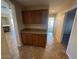 Hallway with a built-in dry bar that features granite countertops, tiled floor, and view of living room and bedroom at 8179 W Clara Ln, Peoria, AZ 85382