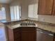 Kitchen offers stainless steel sink, granite countertops, and updated appliances at 8179 W Clara Ln, Peoria, AZ 85382