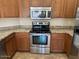 Stainless steel oven with wood cabinets and granite countertops create this modern kitchen at 8179 W Clara Ln, Peoria, AZ 85382