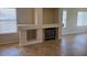 Living room with modern fireplace, tile flooring, and three large windows at 8179 W Clara Ln, Peoria, AZ 85382