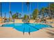 Relax by the community pool with lounge chairs and ladders for easy access on a clear day at 8201 N 21St Dr # C204, Phoenix, AZ 85021