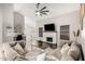 Spacious living room featuring a fireplace, modern ceiling fan, and inviting furnishings at 9126 W Banff Ln, Peoria, AZ 85381