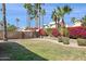 Beautiful backyard with lush landscaping, decorative plants, and privacy wall at 9264 E Hillery Way, Scottsdale, AZ 85260