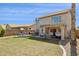 Spacious backyard featuring a patio, outdoor dining area, a play structure and mature palm trees at 9264 E Hillery Way, Scottsdale, AZ 85260