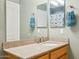 Bathroom vanity features a neutral countertop, wood cabinets, and a large mirror at 9264 E Hillery Way, Scottsdale, AZ 85260
