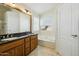 Well-lit bathroom featuring double sinks, a large mirror, and a soaking tub, perfect for relaxation and comfort at 9264 E Hillery Way, Scottsdale, AZ 85260