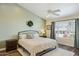 Comfortable bedroom with soft green walls, a ceiling fan, and a large window offering a pleasant view at 9264 E Hillery Way, Scottsdale, AZ 85260