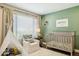 Bright Bedroom features a white teepee, neutral chair, and a crib against a green accent wall at 9264 E Hillery Way, Scottsdale, AZ 85260