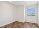Bright bedroom with wood-look flooring and ample natural light from a window at 9264 E Hillery Way, Scottsdale, AZ 85260