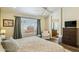 Serene bedroom featuring a large window with curtains and view, with ensuite bathroom access and great natural light at 9264 E Hillery Way, Scottsdale, AZ 85260