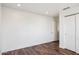 A bright, airy bedroom featuring wood floors and an adjacent closet at 9264 E Hillery Way, Scottsdale, AZ 85260