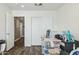 A bedroom with brown floors, white walls, and sliding closet doors at 9264 E Hillery Way, Scottsdale, AZ 85260