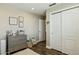 Bright room with white walls and dresser, featuring double sliding door closet and neutral carpet at 9264 E Hillery Way, Scottsdale, AZ 85260