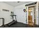 Exercise room with a treadmill, wall equipment, and access to an adjacent bathroom at 9264 E Hillery Way, Scottsdale, AZ 85260