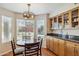 Bright breakfast nook with a round table, hardwood floors, and lots of cabinet space at 9264 E Hillery Way, Scottsdale, AZ 85260