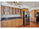 Kitchen boasts stainless steel appliances, wooden cabinets, and granite countertops at 9264 E Hillery Way, Scottsdale, AZ 85260