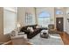 Comfortable living room featuring high ceilings, hardwood floors and large windows at 9264 E Hillery Way, Scottsdale, AZ 85260